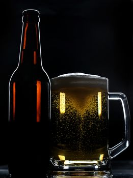 beer bottle and glass with spinning bubbles on black background