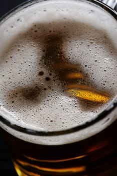 close up of small bubbles on beer foam in glass