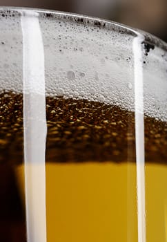 close up of Glass brown beer with foam 