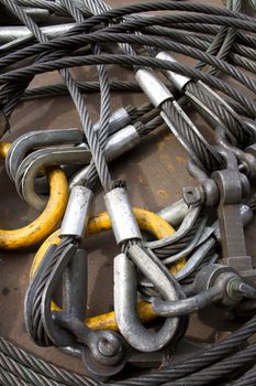 Heavy duty steel wire rope sling with safety anchor shackle bolt in construction site.