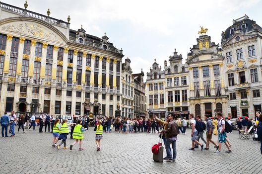 Brussels, Belgium - May 13, 2015: Many tourists visiting famous Grand Place (Grote Markt) the central square of Brussels. The square is the most important tourist destination and most memorable landmark in Brussels.