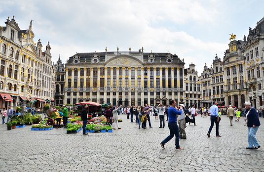 Brussels, Belgium - May 13, 2015: Many tourists visiting famous Grand Place the central square of Brussels. The square is the most important tourist destination and most memorable landmark in Brussels. 