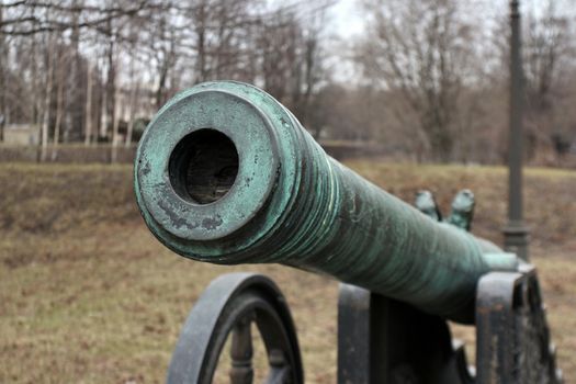 old medieval bronze cannon on the gun carriage front view