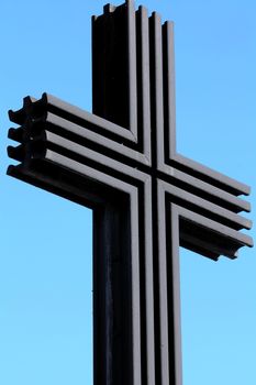 black iron cross on a background of blue sky