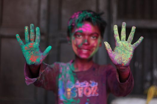 INDIA, Allahabad : An Indian boy celebrates the Holi festival in Allahabad on March 23, 2015. Holi, the Hindu spring festival or 'Festival of Colours' is celebrated with coloured powder and water and marks the end of winter and the beginning of spring. 