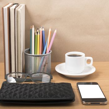 office desk : coffee with phone,stack of book,eyeglasses,wallet,color pencil box on wood background