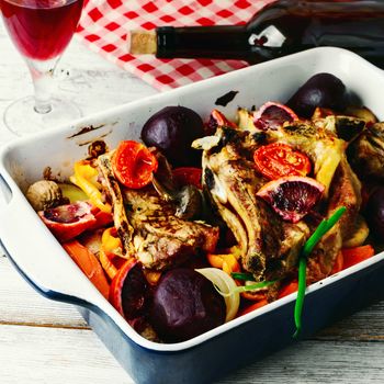 Baked meat with vegetables in a red wine