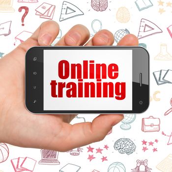 Learning concept: Hand Holding Smartphone with  red text Online Training on display,  Hand Drawn Education Icons background