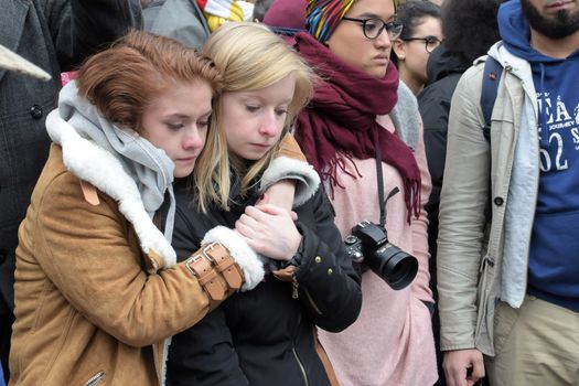 BELGIUM, Brussels: Two girls cry as people gather to observe a minute of silence in memory of the victims of the Brussels airport and metro bombings, on the Place de la Bourse in central Brussels, on March 23, 2016, a day after the triple blasts killed at least 31 people and left around 250 injured. World leaders united in condemning the carnage in Brussels and vowed to combat terrorism, after Islamic State bombers killed around 35 people in a strike at the symbolic heart of the EU.
