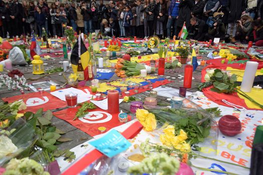 BELGIUM, Brussels: People gather to observe a minute of silence in memory of the victims of the Brussels airport and metro bombings, on the Place de la Bourse in central Brussels, on March 23, 2016, a day after the triple blasts killed at least 31 people and left around 250 injured. World leaders united in condemning the carnage in Brussels and vowed to combat terrorism, after Islamic State bombers killed around 35 people in a strike at the symbolic heart of the EU.