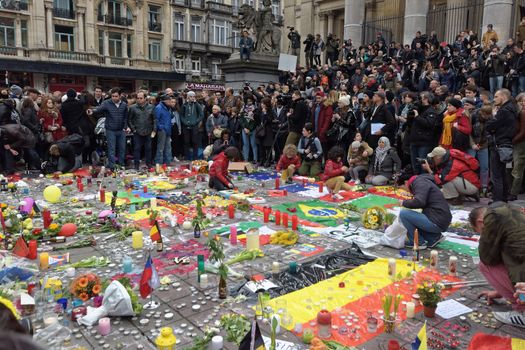 BELGIUM, Brussels: People gather to pay tribute to the victims of the Brussels airport and metro bombings, on the Place de la Bourse in central Brussels, on March 23, 2016, a day after the triple blasts killed at least 31 people and left around 250 injured. World leaders united in condemning the carnage in Brussels and vowed to combat terrorism, after Islamic State bombers killed around 35 people in a strike at the symbolic heart of the EU.