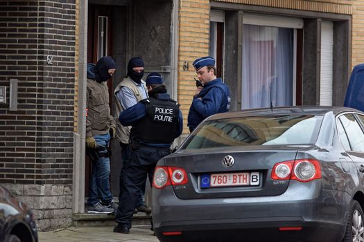 BRUSSELS, Anderlecht: Members of Belgian police make searches at a flat in Anderlecht on March 23, 2016, Belgium. Earlier an arrest was made in connection with the Brussels terrorist attacks. Belgium is observing three days of national mourning after 34 people were killed in a twin suicide blast at Zaventem Airport and a further bomb attack at Maelbeek Metro Station. Two brothers are thought to have carried out the airport attack and an international manhunt is underway for a third suspect. The attacks come just days after a key suspect in the Paris attacks, Salah Abdeslam, was captured in Brussels.