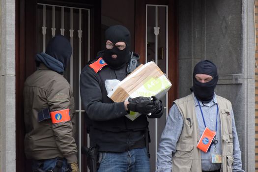 BRUSSELS, Anderlecht: Members of Belgian police make searches at a flat in Anderlecht on March 23, 2016, Belgium. Earlier an arrest was made in connection with the Brussels terrorist attacks. Belgium is observing three days of national mourning after 34 people were killed in a twin suicide blast at Zaventem Airport and a further bomb attack at Maelbeek Metro Station. Two brothers are thought to have carried out the airport attack and an international manhunt is underway for a third suspect. The attacks come just days after a key suspect in the Paris attacks, Salah Abdeslam, was captured in Brussels.