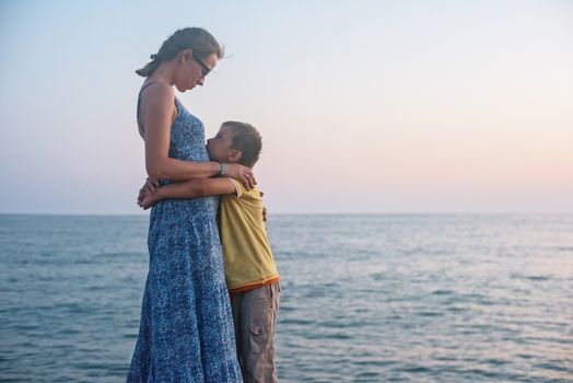 mother and son on the pier in the evening at Alania, Turkey