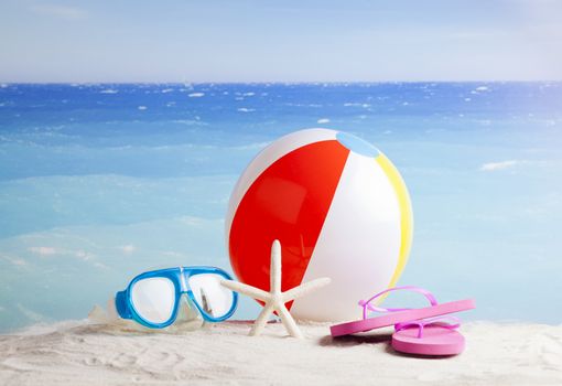 sandy beach with summer accessories and copy space around objects