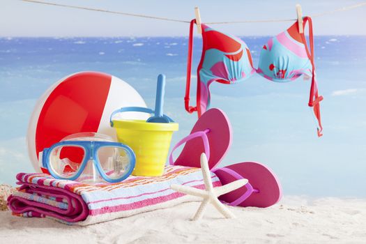 sandy beach with summer accessories and copy space around objects