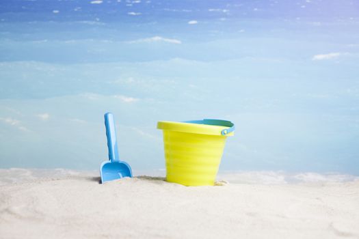 sandy beach with summer accessories and copy space around objects