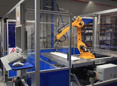 Industrial robotic arm in electronics production line 