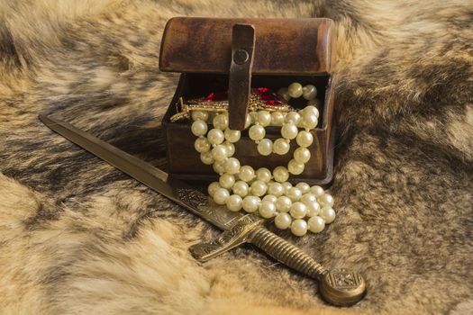 a casket and dagger with jewels on natural fur a wild Wolf