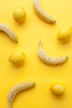 Peel banana and fruit and lemons  on a yellow background and colorful background