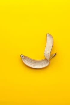 Peel banana  on a yellow background and colorful background