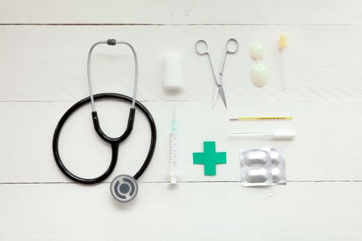 Portable and instrumental retro medical computer on white wooden background