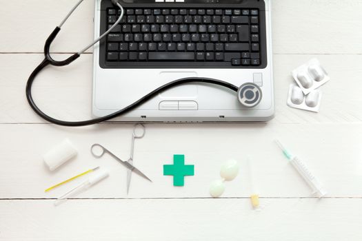 Portable and instrumental retro medical computer on white wooden background