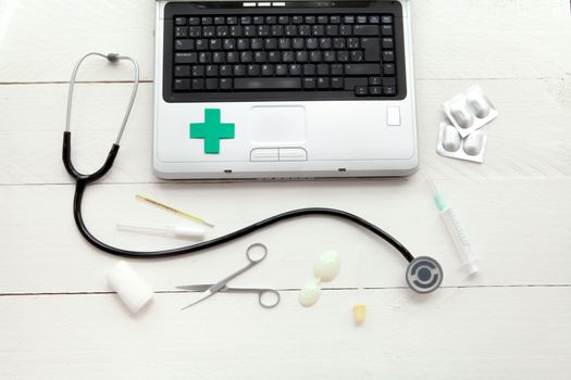 Portable and instrumental retro medical computer on white wooden background