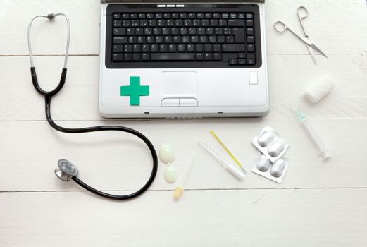 Portable and instrumental retro medical computer on white wooden background