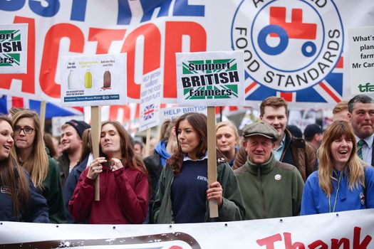 ENGLAND, London: Demonstrators hold up signs during a farmers rally in London, on March 23, 2016. The march intends to raise awareness, as many farmers across the region are facing an economic crisis. Participants gathered at Waterloo Place and marched to Downing Street. The event was organized by the Farmers For Action (FFA).