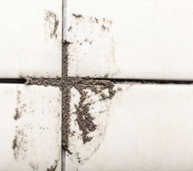 ceramic tiles on the wall in a dirty cement