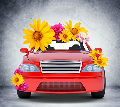 Car with flowers on grey wall background