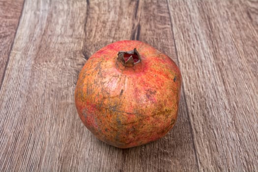Pomegranate on a brown wooden background