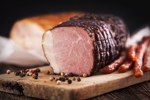 Delicious ham on wooden desk closeup, studio shot