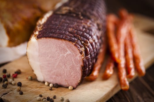 Delicious ham on wooden desk closeup, studio shot