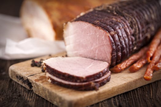 Delicious ham on wooden desk closeup, studio shot