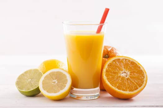 Healthy and fresh mixed juice from fruits on white wooden table