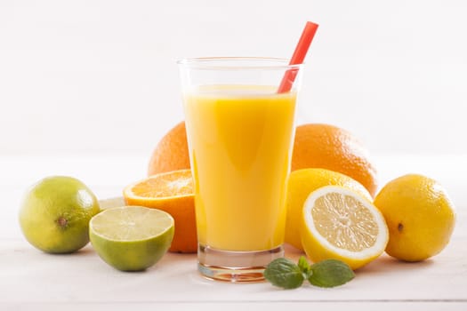 Healthy and fresh mixed juice from fruits on white wooden table