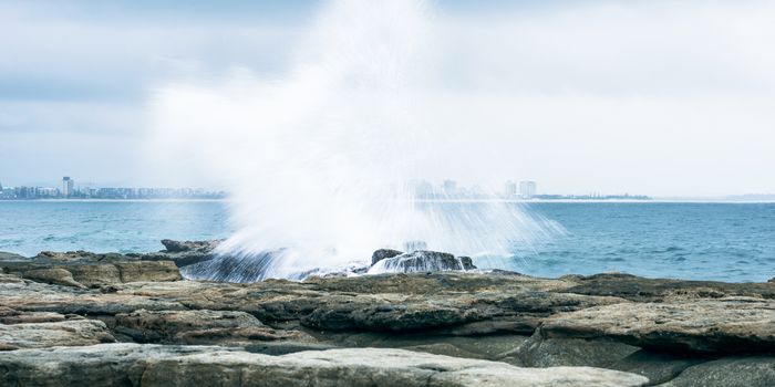 Rocks and waves at Point Cartwright beach in the afternoon. Sunshine Coast, Queensland.