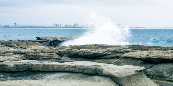 Rocks and waves at Point Cartwright beach in the afternoon. Sunshine Coast, Queensland.