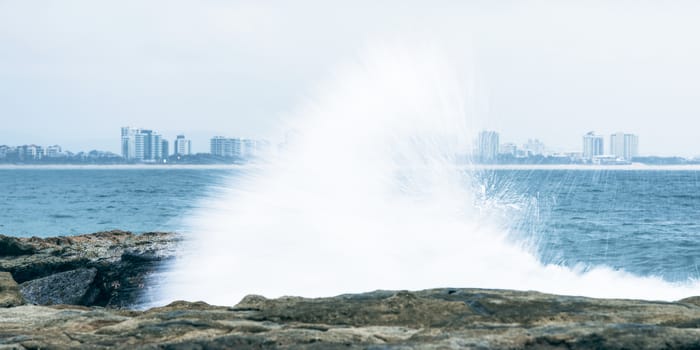 Rocks and waves at Point Cartwright beach in the afternoon. Sunshine Coast, Queensland.