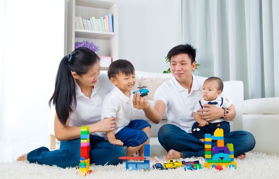 Asian family playing toys