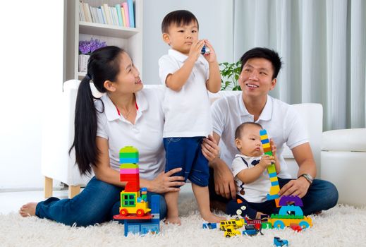 Asian family playing toys