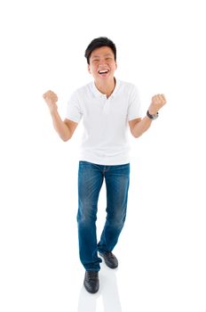 Portrait of excited asian businessman celebrating success over white background