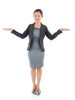 Excited full body Asian business woman standing on plain background.