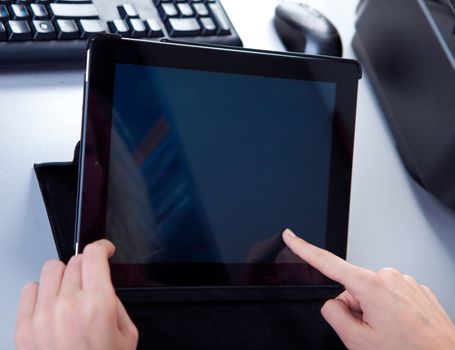 business woman in the workplace is working on a tablet