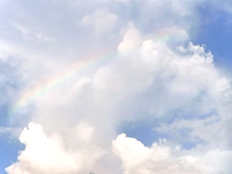 rainbow in the blue sky after