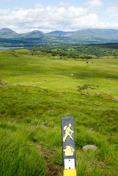 hiking signpost with mountain view from the kerry way walk in ireland