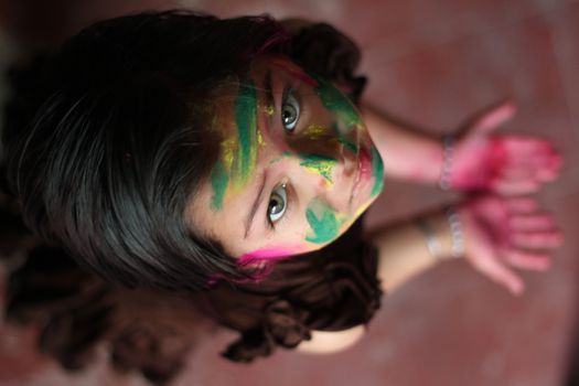 INDIA, Allahabad: A child wears vibrantly colored paints during Holi celebrations in Allahabad, India on March 24, 2016. Hindu devotees splatter each other with paint during Holi celebrations to mark the advent of spring. It is celebrated across the country and in many other countries in the region.
