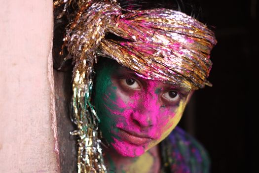 INDIA, Allahabad: A child wears vibrantly colored paints during Holi celebrations in Allahabad, India on March 24, 2016. Hindu devotees splatter each other with paint during Holi celebrations to mark the advent of spring. It is celebrated across the country and in many other countries in the region.